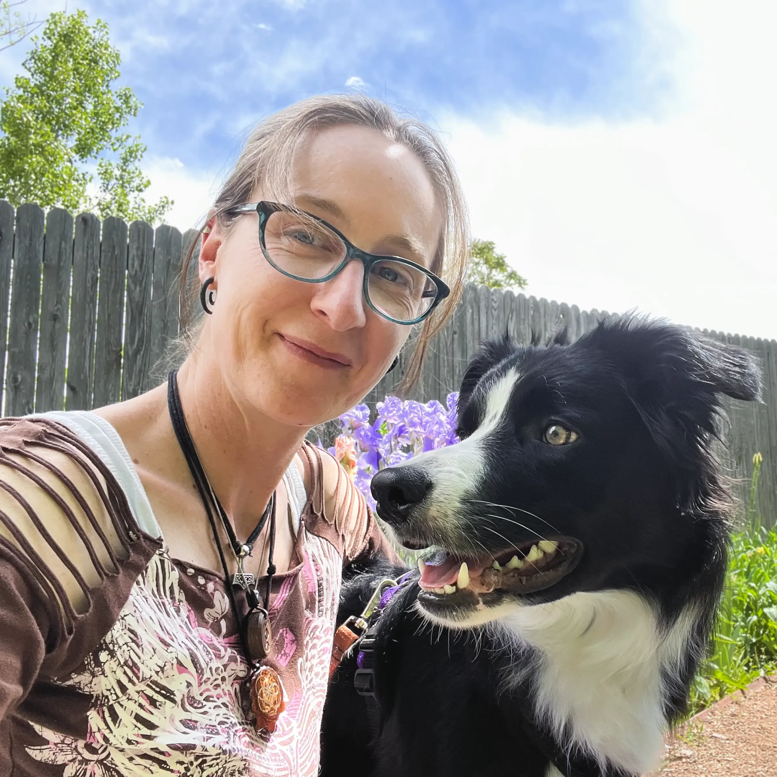 Kathleen Valentine, dog trainer, with her dog in a backyard in Lafayette, Colorado