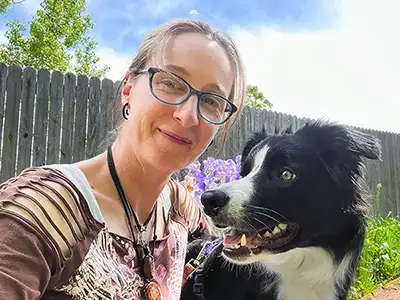 Kathleen Valentine, dog trainer, with her dog in a backyard in Lafayette, Colorado